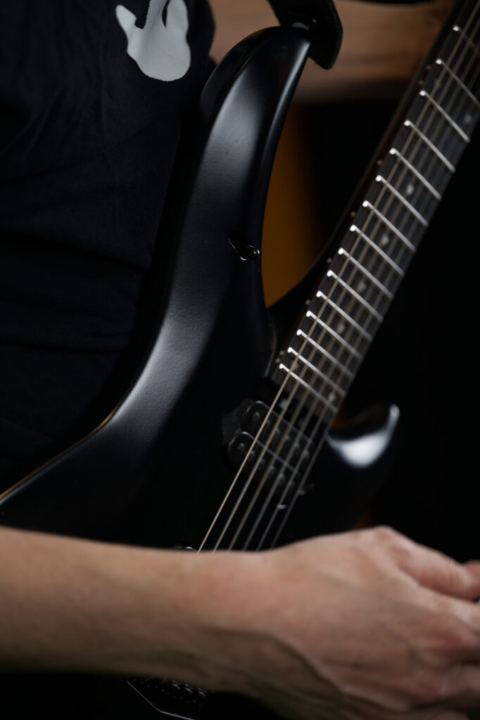 Closeup of a black electric guitar